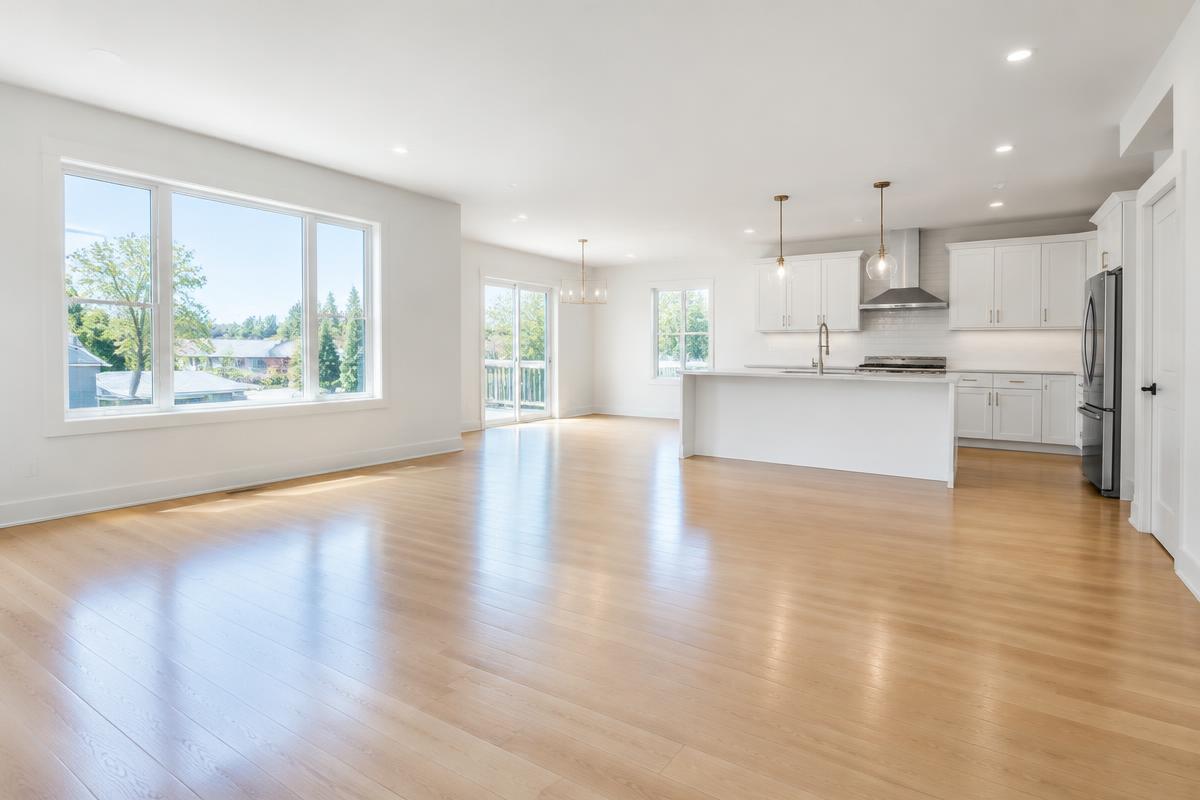 Newly renovated open-plan living room and kitchen with clean wood floors